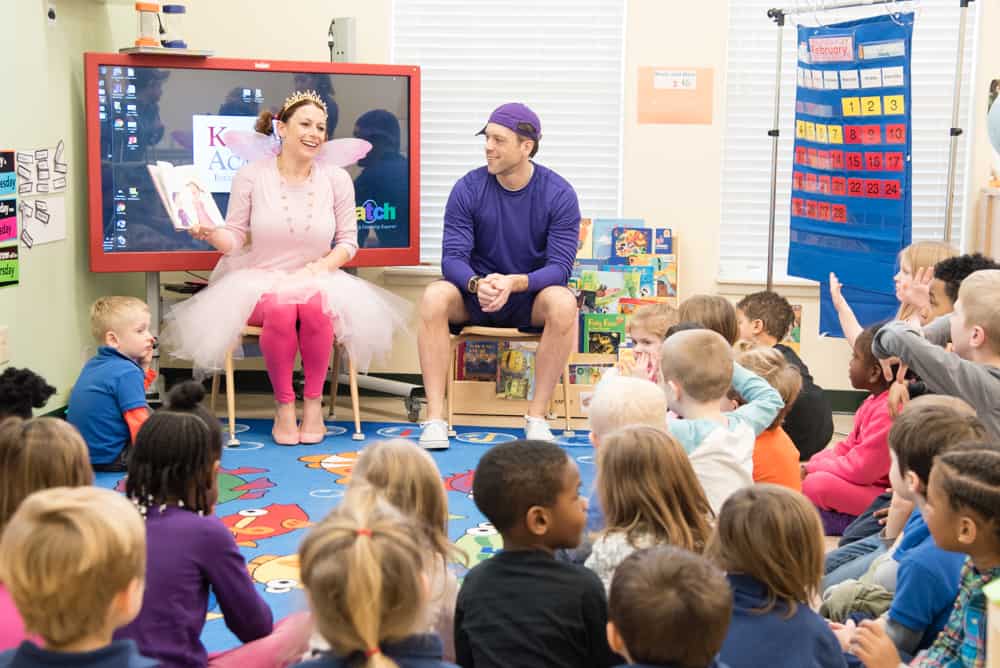 Teacher dressed like a fairy telling story to children in class