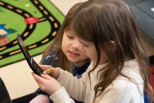 Kiddie Academy kids explore flip phone